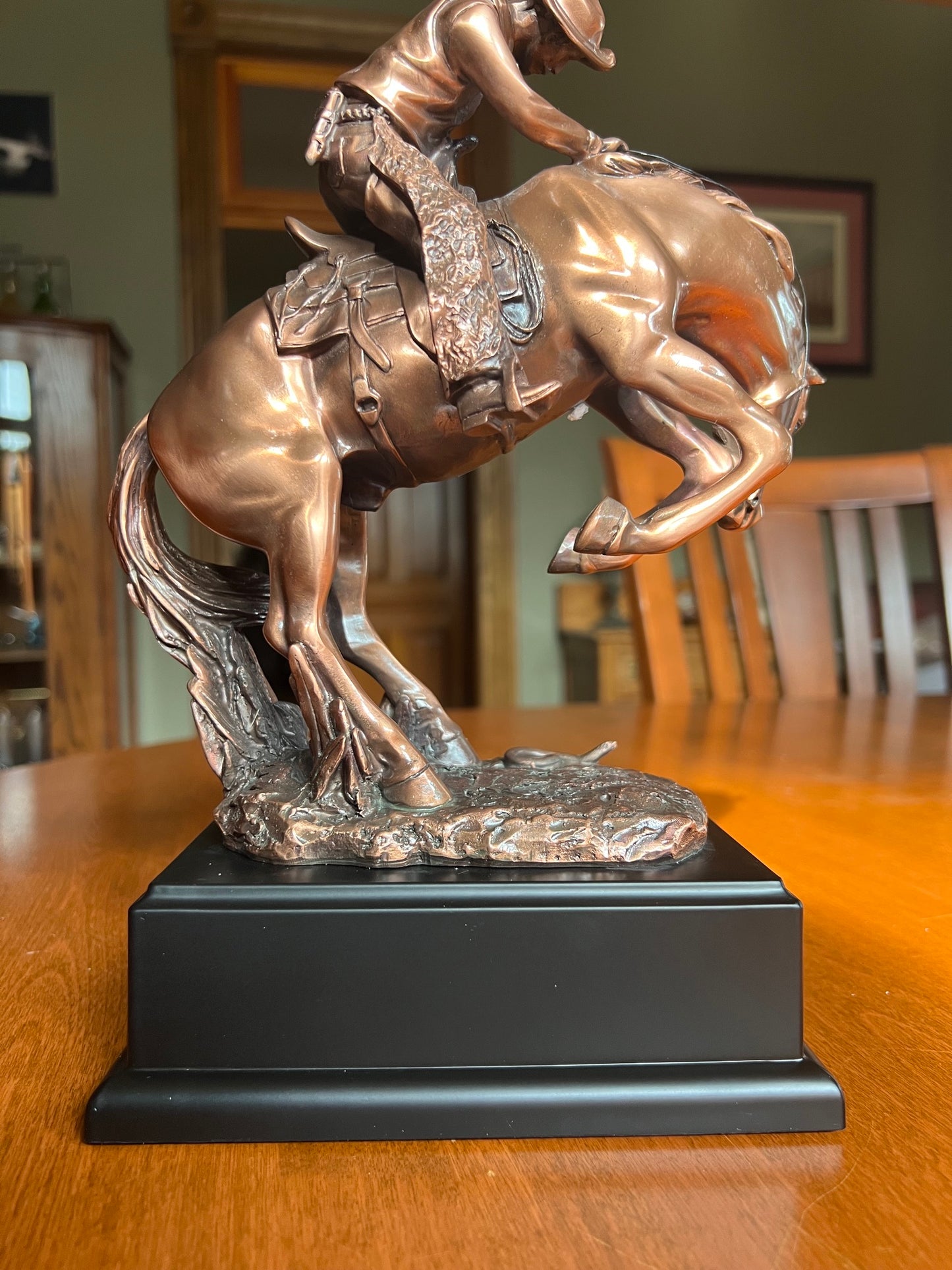 back view of statue Snake on the Trail Cowboy Bronco Sculpture
