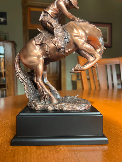 back view of statue Snake on the Trail Cowboy Bronco Sculpture