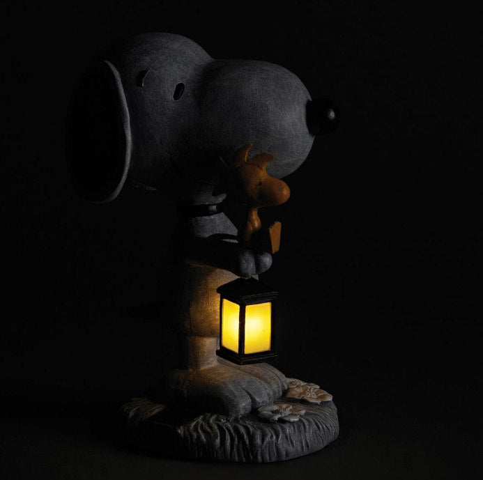 Solar Snoopy & Woodstock Garden Statue shown at night with light glowing