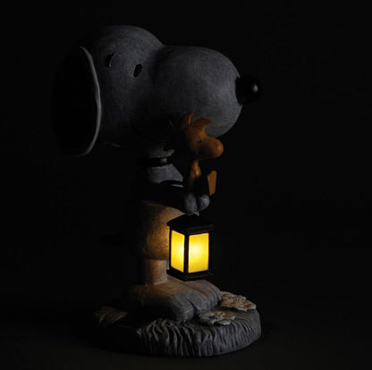 Solar Snoopy & Woodstock Garden Statue shown at night with light glowing