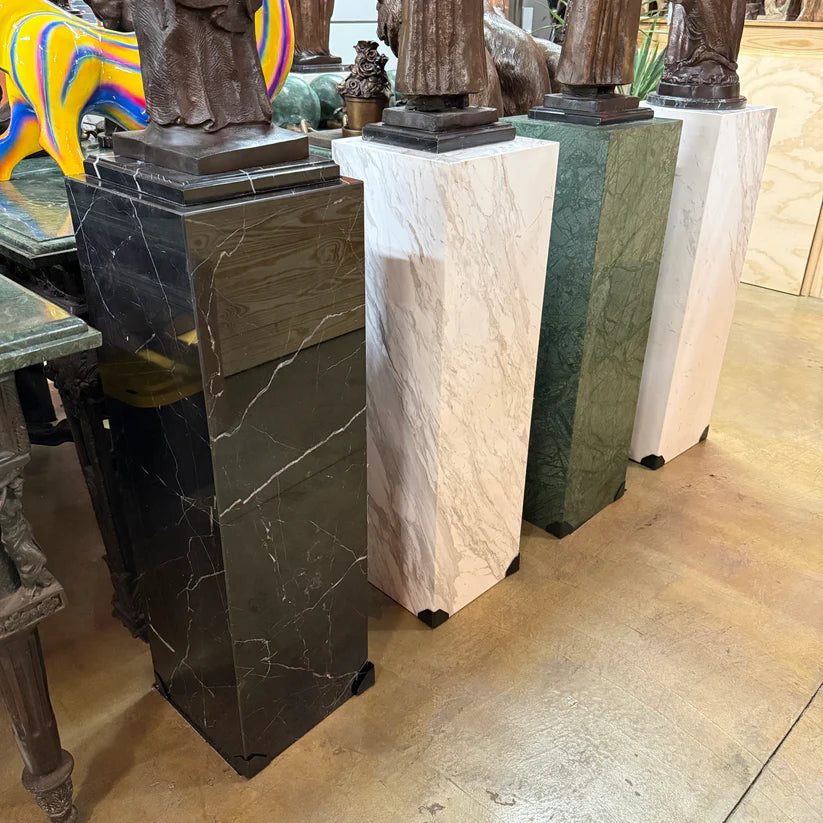 Modern black marble pedestal column for sculpture display close up of color