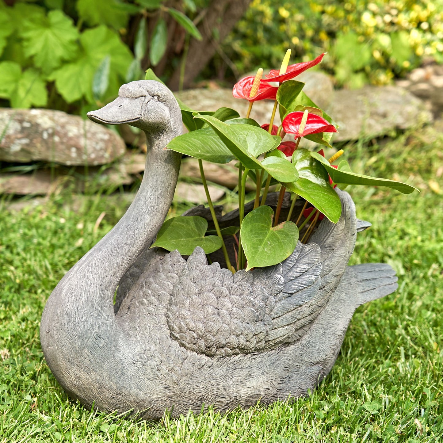 Tall swan planter set with head up and head down garden sculptures holding flowers
