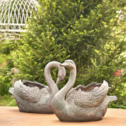 Tall swan planter set with head up and head down designs, inspired by classical garden art outdoor spaces.