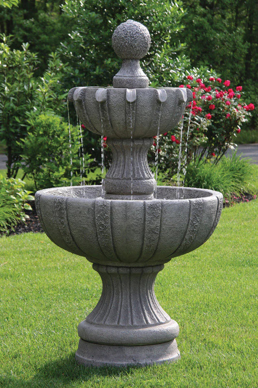 Stone garden fountain with water feature in a garden setting