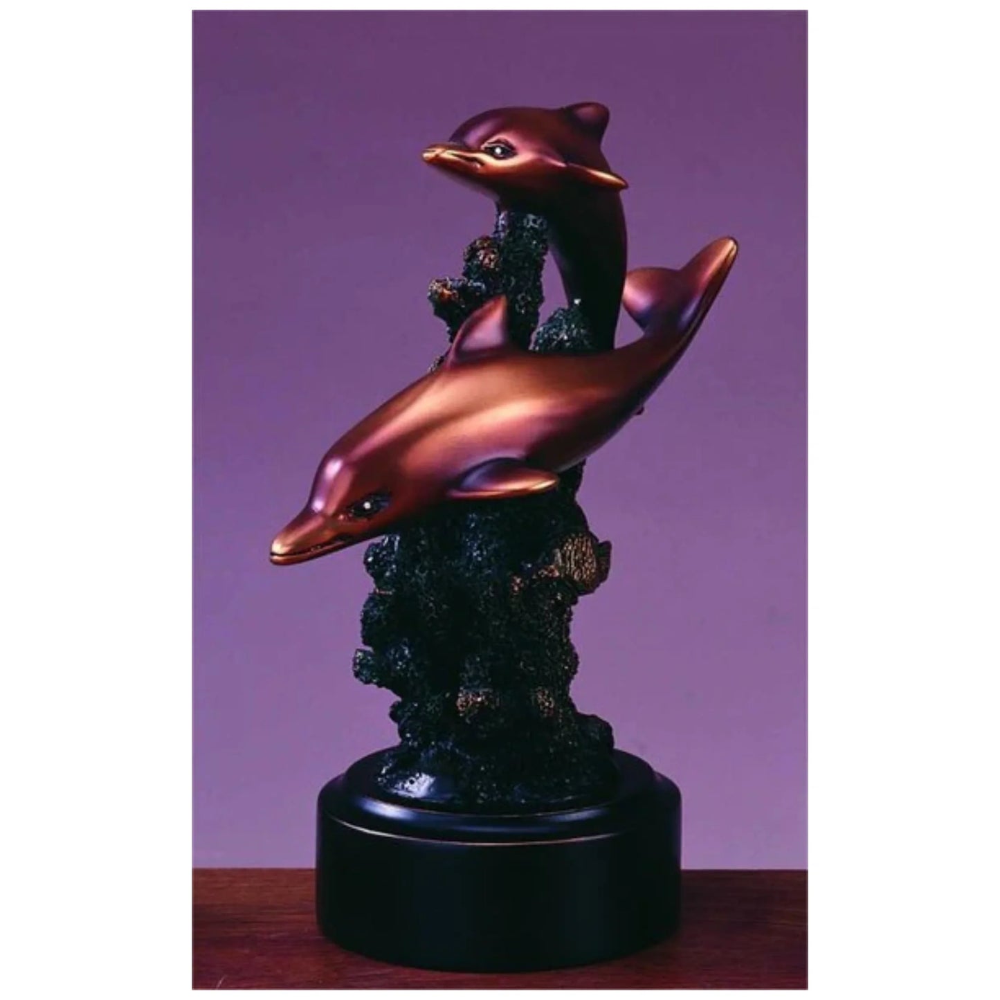 Dolphin statue features two sleek bronze-finished dolphins leaping over coral, crafted in designer resin—an elegant sea life accent for coastal or nautical décor.