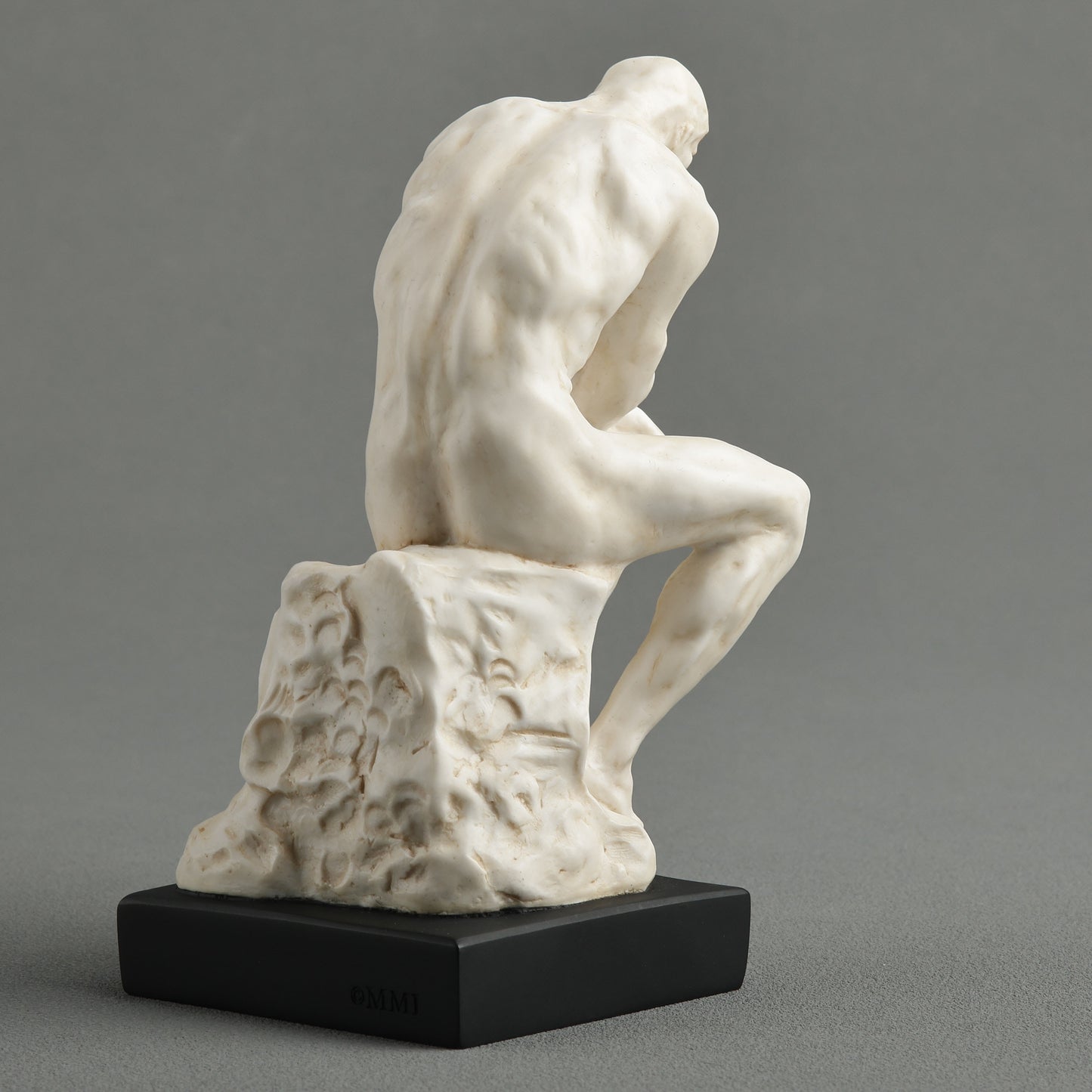 White marble finish Rodin Thinker statue on black base back view of sculpture famous reproduction