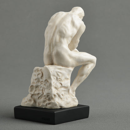 White marble finish Rodin Thinker statue on black base back view of sculpture famous reproduction