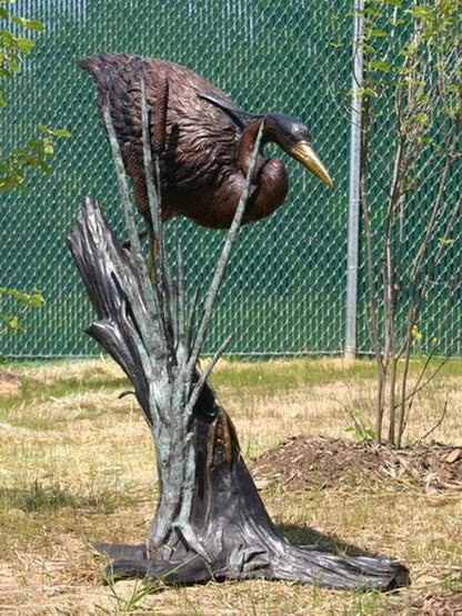life size bronze statue heron or crane outdoor bird sculpture walking in Reeds
