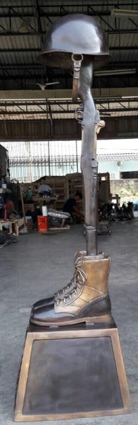 War Memorial Battle Cross Boots WW II with old era rifle sculpture