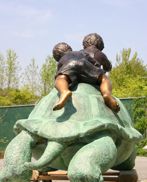 Two Boys Riding Turtle Bronze Statue