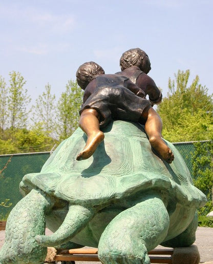 Two Boys Riding Turtle Bronze Statue