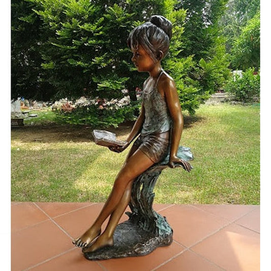 Girl Reading book hair up in a bun sculpture made of bronze Libaries