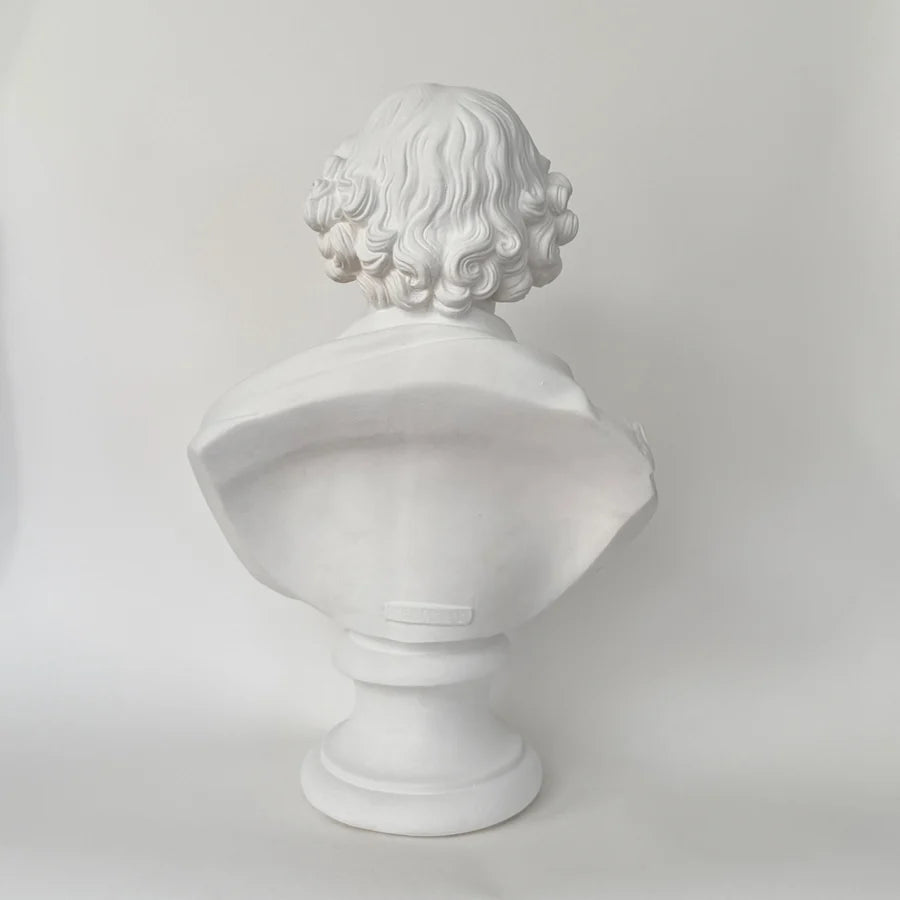 A white classical-style bust sculpture of a person with curly hair, shown from the back white classical-style William Shakespeare bust sculpture