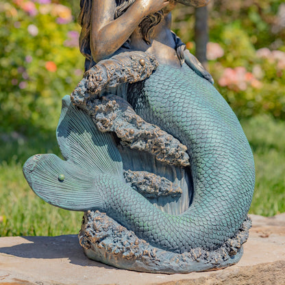 Close-up of the mermaid tail showing individually sculpted scales and muted teal-green patina