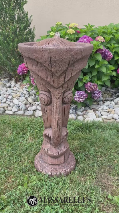 Video Tiki luau outdoor fountain made of cement water flowing from top tropical poolside garden